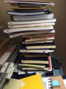 precarious pile of some (not all) used and new notebooks in my home office